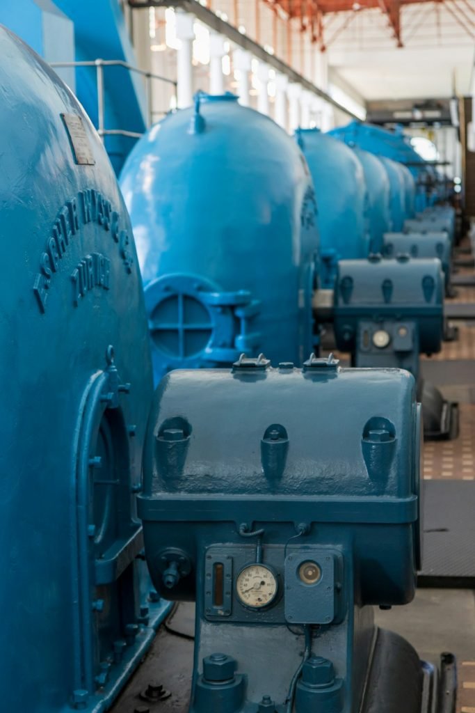 a-row-of-blue-tanks-sitting-next-to-each-other-hhmhq1jxfmc