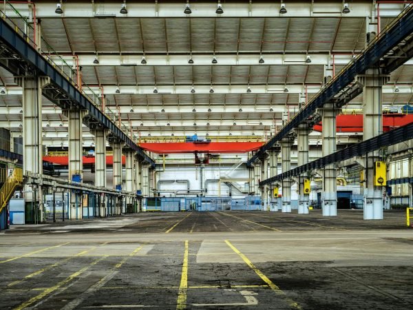 Expansive industrial warehouse interior showcasing steel framework and spacious layout for diverse manufacturing needs.